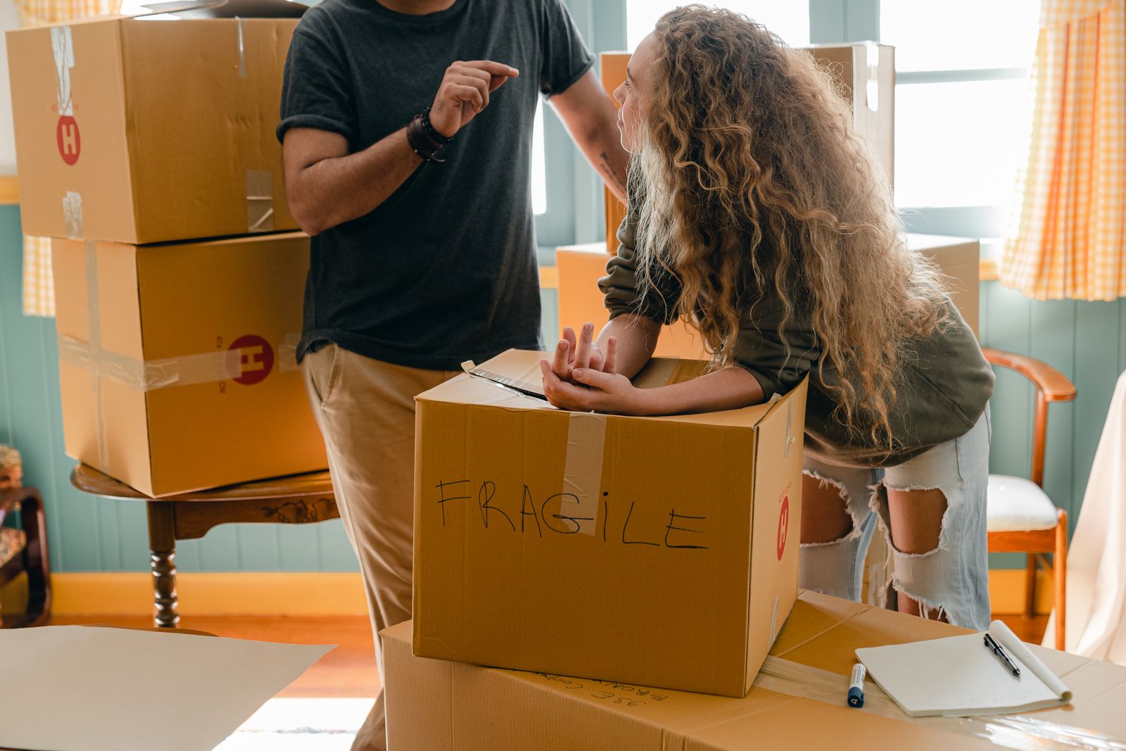 A couple planning their Nairobi move around stacked boxes