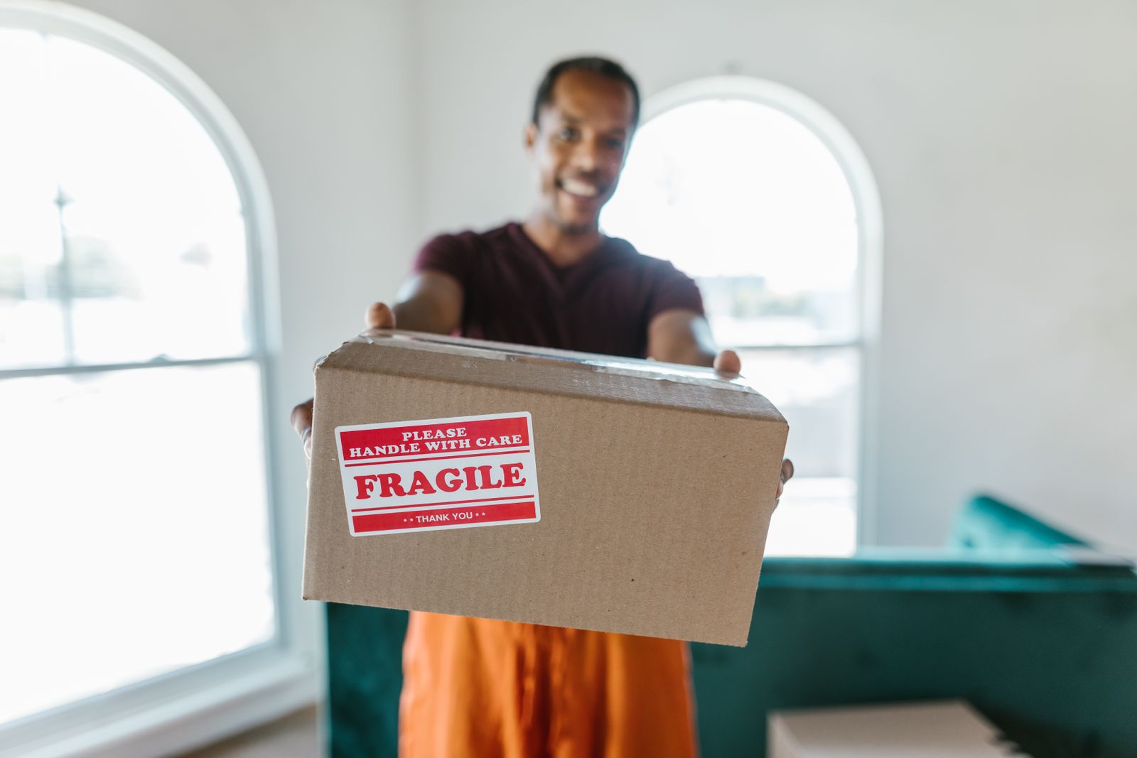 A Nyati Movers crew member handling a box marked fragile