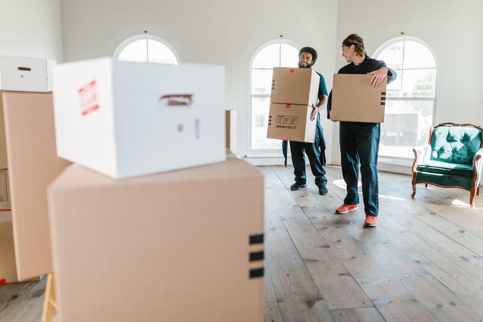 Nyati Movers crew carrying labelled boxes through a living room
