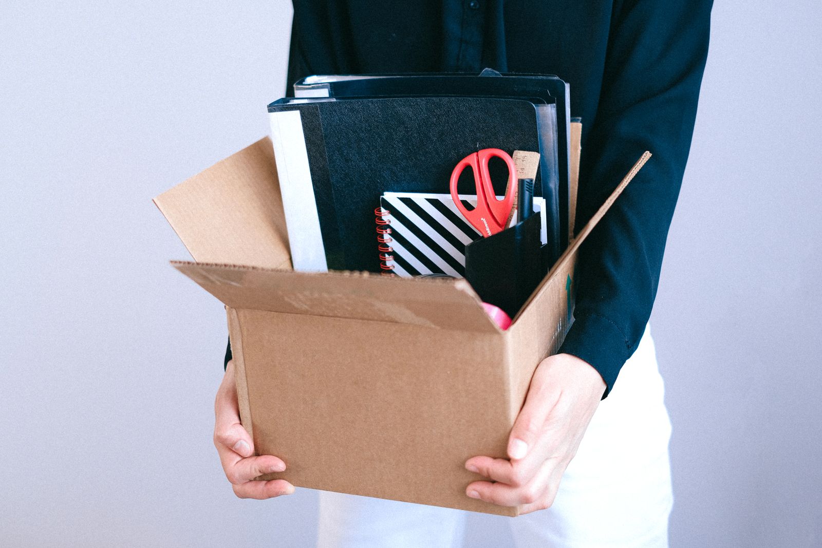 A box of office supplies packed and ready for the move