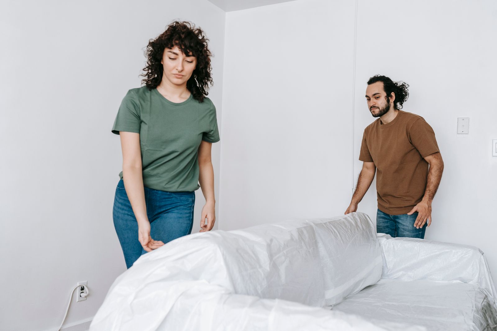 A sofa being wrapped in protective plastic before a Nyati Movers house move